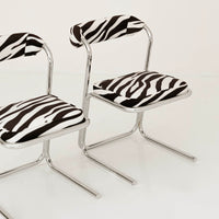 Vintage chrome chairs upholstered in zebra-print velvet