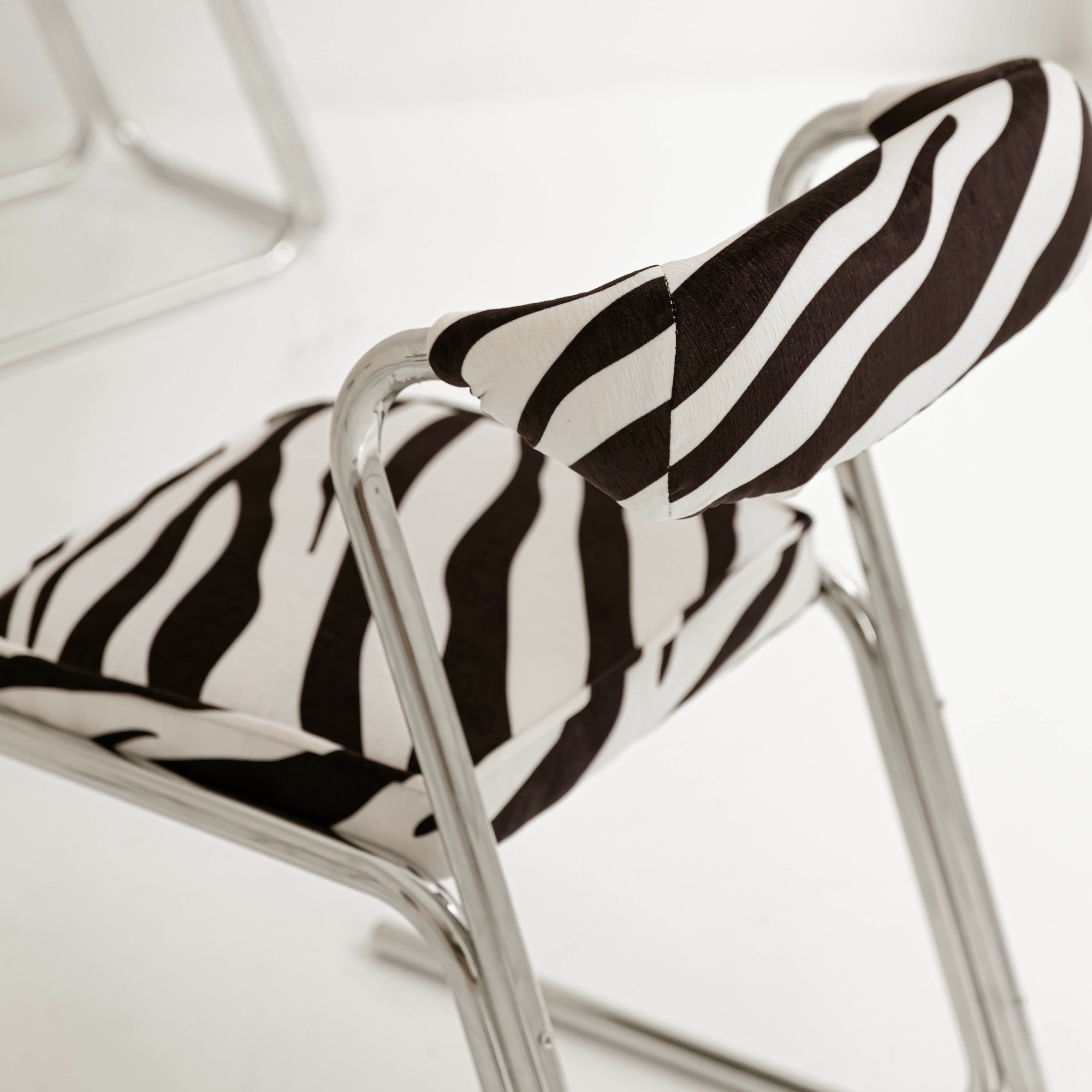 Vintage chrome chairs upholstered in zebra-print velvet